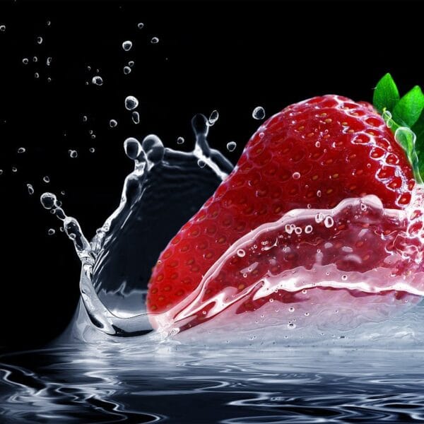 Dynamic shot of a strawberry splashing into water with vivid colors against a black background.